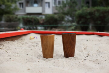 Elegant handmade wood water glass or wooden cup isolated on white background.