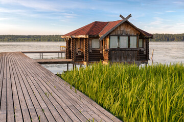 Gazebo on the shore of a pond on a summer evening