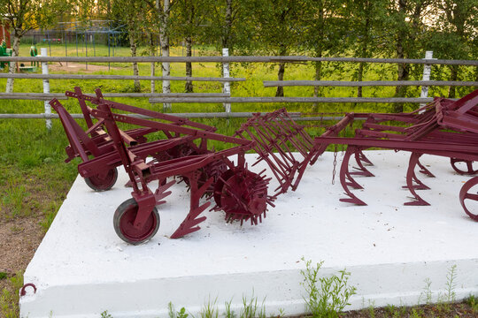 Antique agricultural equipment in a farmyard in the countryside
