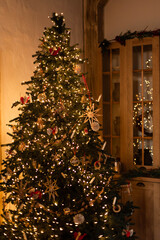 Christmas tree decorated lantern garland with wooden toys. Christmas interior