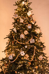 Christmas tree decorated lantern garland with wooden toys. Christmas interior