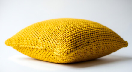 Yellow knitted cushion on white background pillow textile