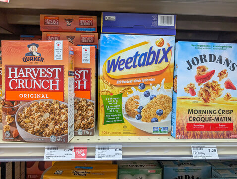 Canada, Quebec, 23 November 2025 : Three popular breakfast cereal boxes displayed on grocery store shelf