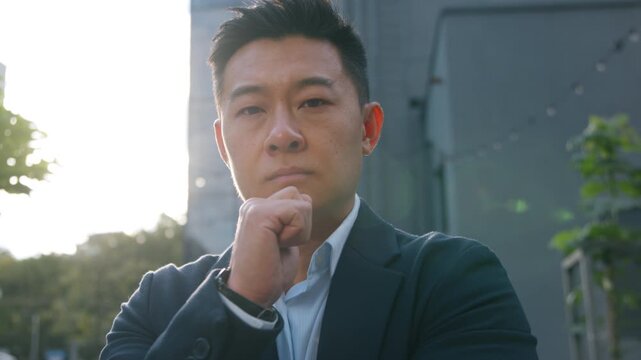 Pensive thinking Asian Korean adult 40s business man Chinese Japanese businessman looking for solution think decide thoughtful outdoor middle-aged male manager pondering job problem in sunny city