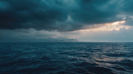 Obraz premium Moody ocean scene, dark stormy clouds above serene, rippled water, islands in the distance