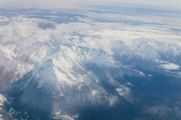 Snow-covered Alpine peaks viewed from airplane