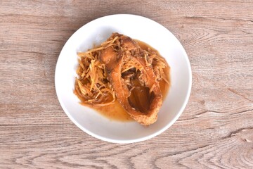 deep fried chop red Tilapia or mango fish slice dressing soy sauce and celery on plate 