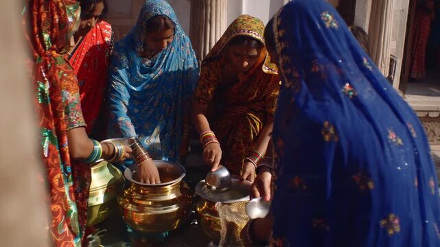 Indian Women Performing Traditional Ritual with Brass Pots and Water