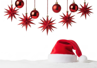 Red santa hat and hanging christmas ornaments, including star shapes and baubles, on a snowy surface, isolated on transparent background