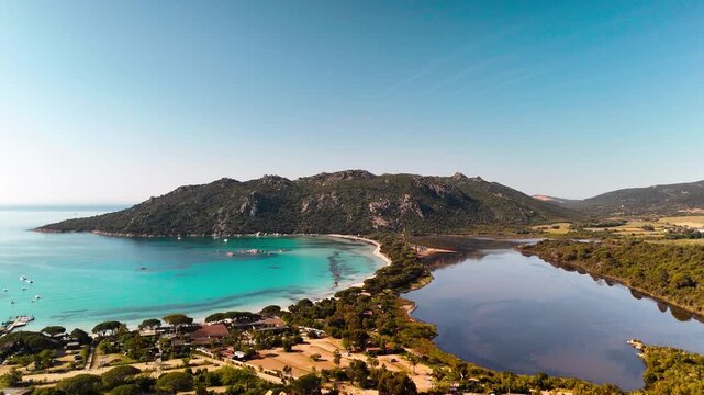 Expansive Aerial Wide Shot Gliding Over Pristine Plage de Santa Giulia Lagoon, Highlighting White Sand Beach and Calm Turquoise Mediterranean Sea, Porto Vecchio, Corsica, France.