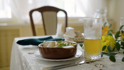 Dining table set with stew and orange juice