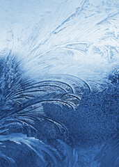 Beautiful ice pattern on window glass, close-up natural winter background