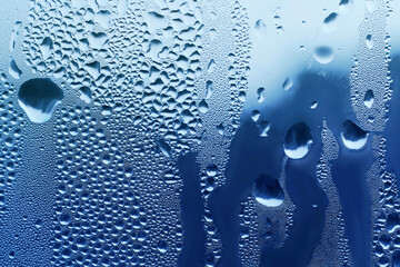 Background with water drops on window glass, close-up natural texture