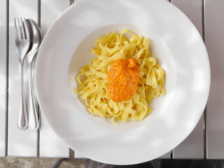 Plate of pasta with a sauce on top