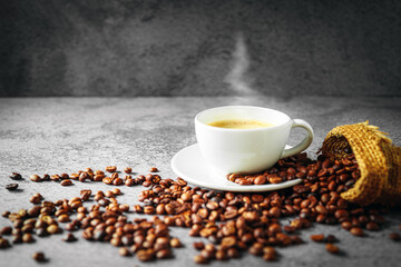 Coffee cup and coffee beans in sack on gray background, Espresso crema coffee cup aromatic