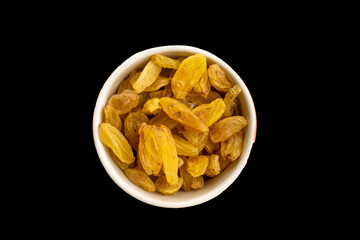 Bright golden sweet raisins isolated on black background, macro.
