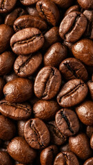 Fototapeta premium Roasted coffee beans background texture. Macro close up of brown espresso seeds. Fresh aroma concept