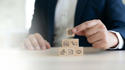 Close up of a businessman s hands stacking wooden blocks with symbols representing financial growth and investment strategies on a table symbolizing business development and success
