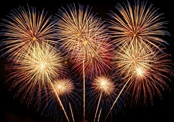 Golden and red fireworks burst in radiant starburst pattern against dark night sky for dazzling celebration

