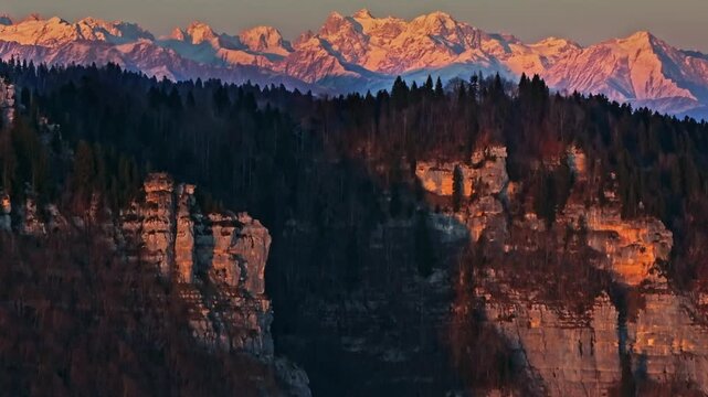Stunning aerial view of revealing Caucasus snowy mountains from the rugged rocks and dense forest, illuminated by a full moon perfectly centered in the sky. winter drone landscape captured from above.