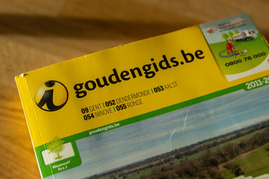 AALST, BELGIUM, 2 DECEMBER 2025: Illustrative editorial image of an obsolete paper phonebook the 'Gouden Gids', the Yellow Pages telephone directory of Flanders, which is now only available digitally.