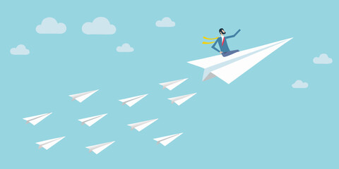 A businessman soaring through the sky on a paper airplane leading the way