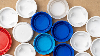 multi-colored plastic lids top view, the concept of food grade plastic recycling. High quality photo