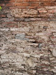 Old brick wall in Thailand, ruins of an old temple, bricks blackened by moisture