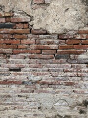 Old brick wall in Thailand, ruins of an old temple, bricks blackened by moisture