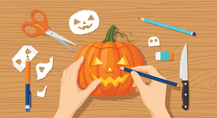 Top-down view of hands carving a jack-o'-lantern pumpkin on a wooden table with various crafting tools for Halloween.