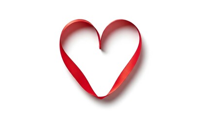 Fototapeta premium Red ribbon formed into a heart shape a symbol of love and romance isolated on a clean white background