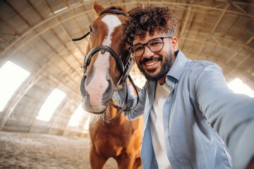Selfie time. Man is with horse in the hangar