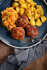 Meatballs  served with fired potatoes.