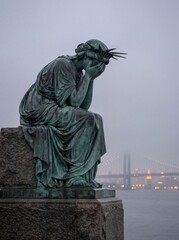 Grieving Liberty Statue on Foggy Waterfront