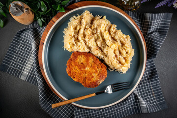 Minced meat cutlet with boiled sauerkraut.