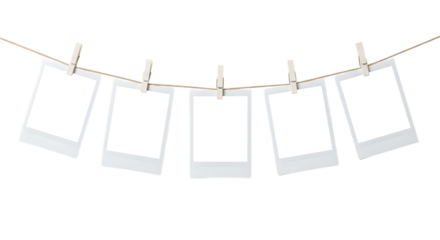 Five blank instant photo frames hang from a rustic twine with wooden clothespins