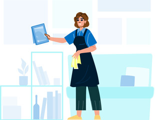 Professional cleaner dusting picture frame during domestic cleaning service