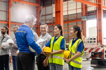 Supervisor of diverse engineers briefing his team before working in manufacturing factory. Leader giving a briefing to team in industrial site. Worker manager conducting a site meeting in a factory.