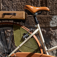 closeup detail of white and orange ladies retro style pedal cycle