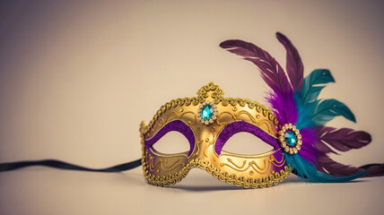 Ornate golden masquerade mask with vibrant purple and teal feathers on a subtle background for festive celebration concept and elegant party atmosphere