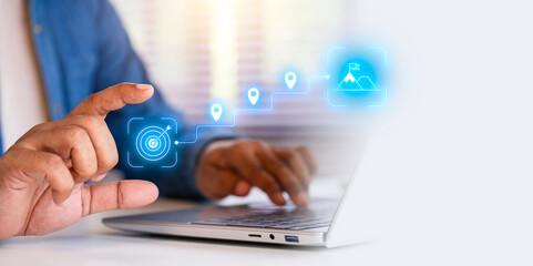 Businessman planning overall goals and direction of the strategy. Project Roadmap Concept. Digital interface on computer with roadmap overlay representing steps in project strategic planning process.