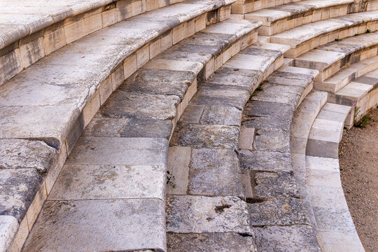 Stepped seating and central stair aisle in the ancient Roman amphitheater at Zippori National Park, Galilee, Israel. Weathered limestone benches reveal centuries of use