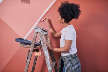 Person Painting Red Wall on Ladder Creating Mural With Brush and Tools © Meeko Media