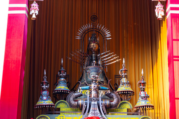 Fototapeta premium A beautifully crafted handmade colorful goddess durga idol decorated for Navratri, featuring vibrant traditional attire, intricate jewellery, and divine expressions at colorful pandal.
