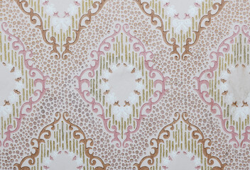 Old wallpaper on the wall. Old wallpaper for texture or background.