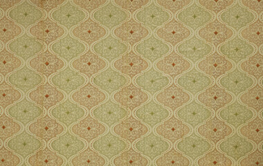 Old wallpaper on the wall. Old wallpaper for texture or background.