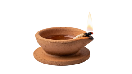 Traditional indian oil lamp diya with lit wick isolated on transparent background