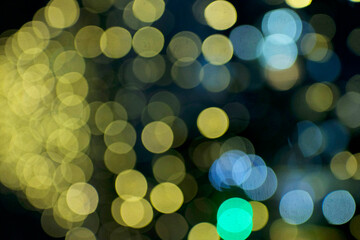 Blurry holiday background at night with blue colored. Bubbles bokeh.