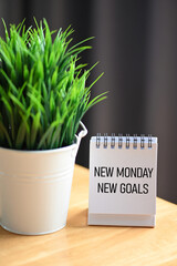 Desk Sign with New Monday New Goals &mdash; Positive Start and Weekly Planning Concept