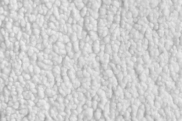 Vibrant white color fabric texture of soft faux fur cloth with fluffy surface, abstract background. Close up, macro of shaggy fabric texture, upholstery material, textile backdrop